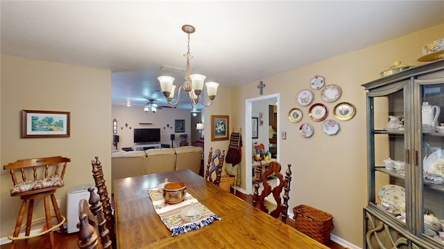dining area with visible vents, baseboards, ceiling fan with notable chandelier, and wood finished floors