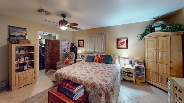 bedroom with light tile patterned floors, ceiling fan, and visible vents