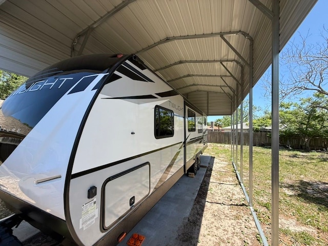exterior space with an attached carport and fence