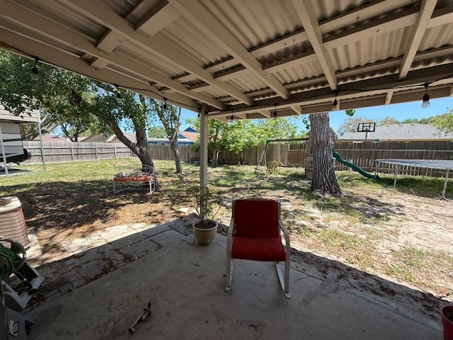 view of patio / terrace featuring a fenced backyard and a trampoline