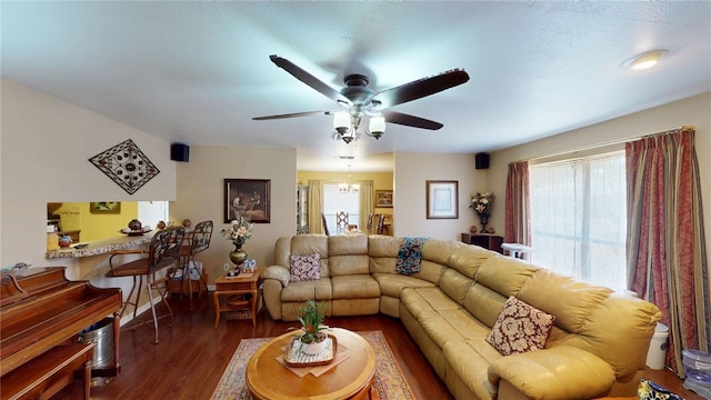 living room featuring dark wood finished floors and a ceiling fan