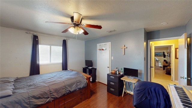 bedroom with wood finished floors and a ceiling fan