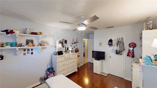 bedroom featuring dark wood-type flooring, ceiling fan, and visible vents