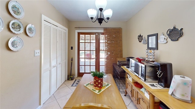 dining room with a notable chandelier and light tile patterned flooring