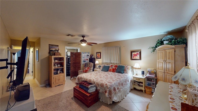 bedroom featuring light tile patterned floors, a ceiling fan, and visible vents
