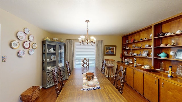 dining area featuring light wood finished floors and a notable chandelier