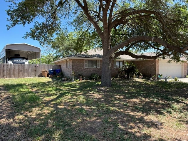 exterior space featuring a carport, driveway, fence, and a garage