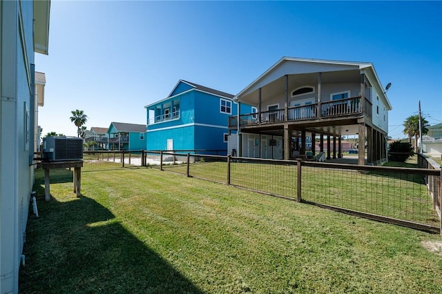 back of property featuring central AC, a wooden deck, and a lawn