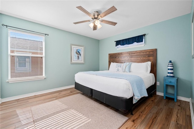 bedroom with wood-type flooring and ceiling fan