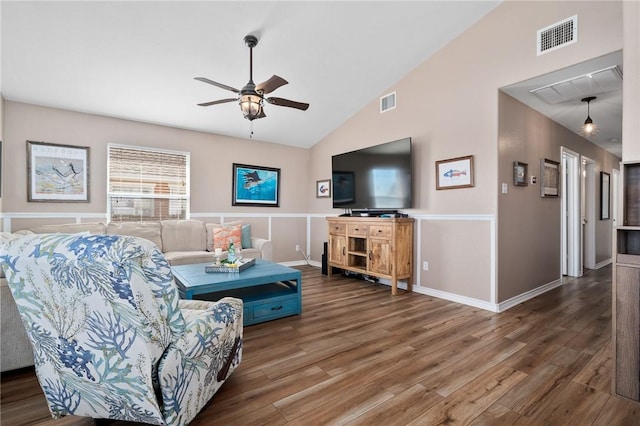 living room with lofted ceiling, ceiling fan, and dark hardwood / wood-style floors