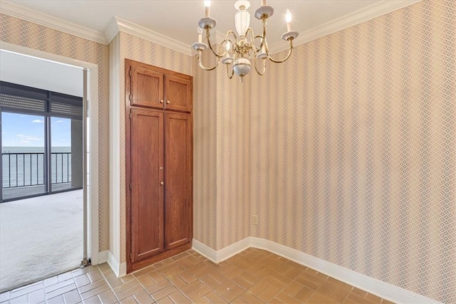 4350 Ocean Dr Unit 103, Corpus Christi, TX 78412 - unfurnished dining area with an inviting chandelier, wallpapered walls, a water view, baseboards, and crown molding