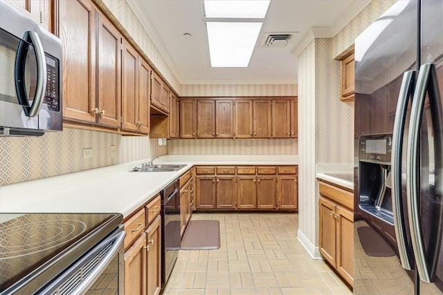 4350 Ocean Dr Unit 103, Corpus Christi, TX 78412 - kitchen with a sink, brick patterned floor, light countertops, wallpapered walls, and appliances with stainless steel finishes