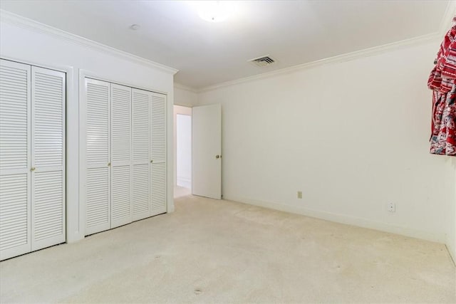 4350 Ocean Dr Unit 103, Corpus Christi, TX 78412 - unfurnished bedroom featuring visible vents, two closets, crown molding, and carpet flooring