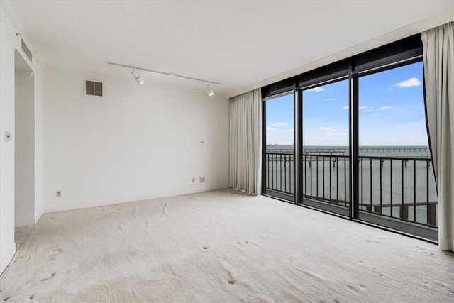 4350 Ocean Dr Unit 103, Corpus Christi, TX 78412 - spare room with a water view, visible vents, rail lighting, and carpet flooring