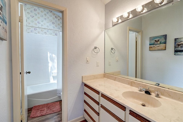 bathroom featuring vanity, wood-type flooring, and bathing tub / shower combination