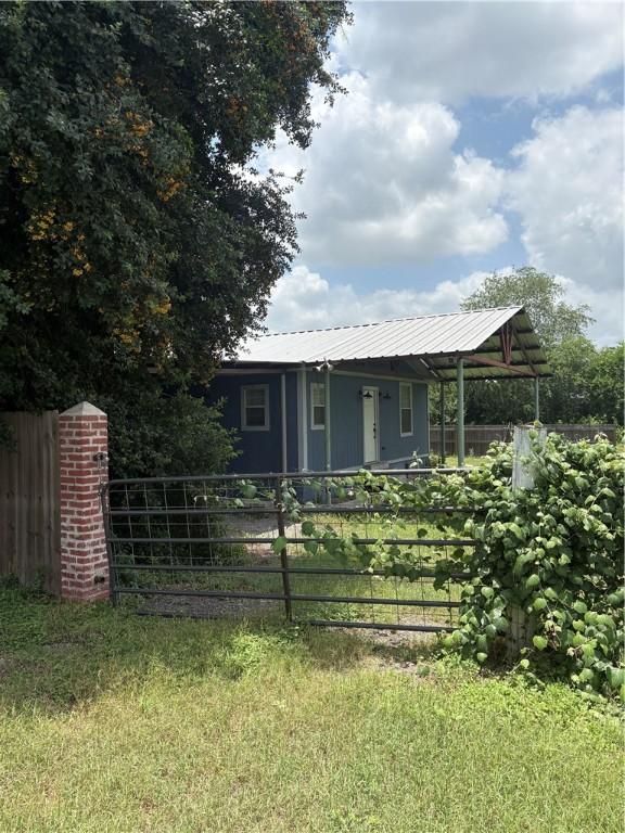 2405 Cox St, Beeville, TX 78102 - view of front of house featuring a metal roof