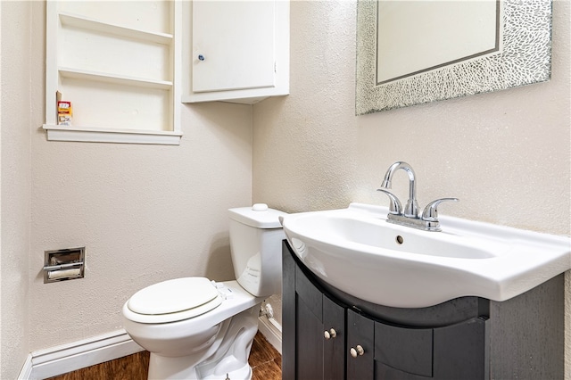 bathroom featuring wood-type flooring, vanity, and toilet