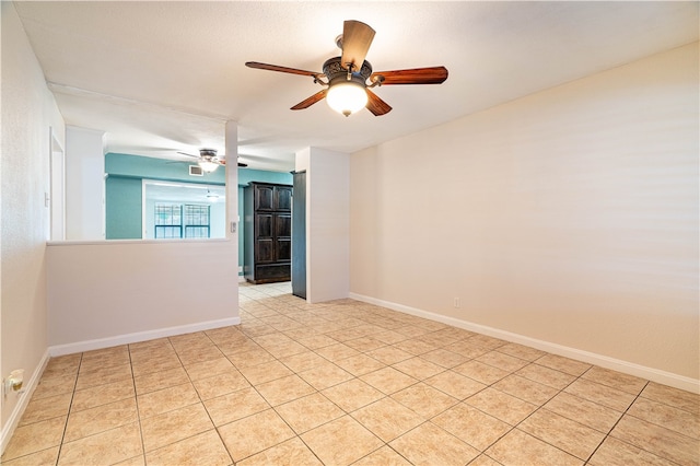 unfurnished room with ceiling fan and light tile patterned floors