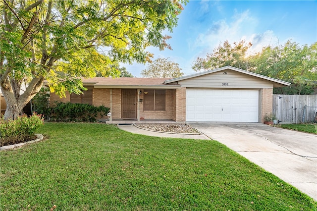 ranch-style home with a garage and a front yard