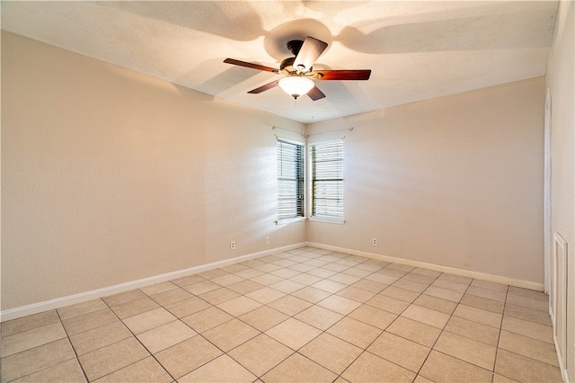 unfurnished room with ceiling fan and light tile patterned floors