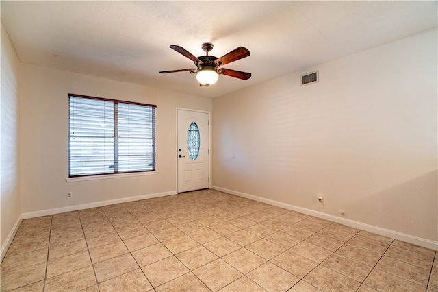 foyer with ceiling fan and light tile patterned floors