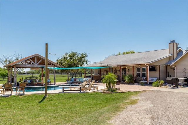 exterior space with a gazebo, a lawn, a patio area, and a pool