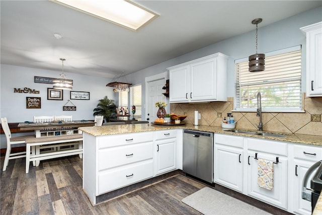 kitchen featuring a peninsula, dark wood-style flooring, a sink, white cabinets, and stainless steel dishwasher