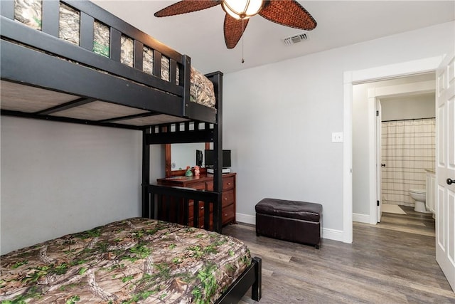 bedroom featuring wood finished floors, visible vents, and baseboards