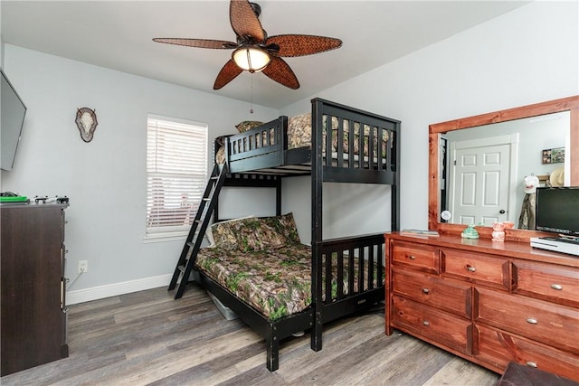 bedroom featuring baseboards and wood finished floors