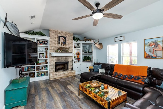 living area with a fireplace, visible vents, ceiling fan, vaulted ceiling, and wood finished floors