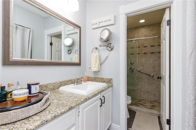 bathroom with toilet, a stall shower, tile patterned flooring, and vanity