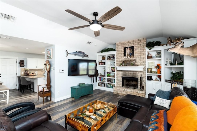 living room with visible vents, a ceiling fan, vaulted ceiling, a brick fireplace, and dark wood-style floors