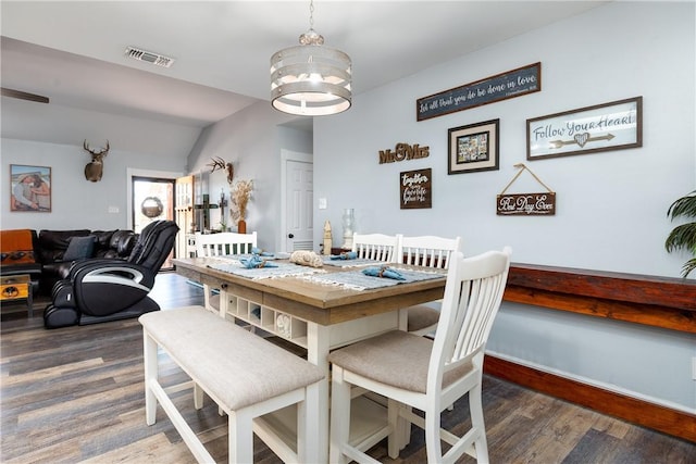 dining space featuring a chandelier, visible vents, baseboards, and wood finished floors