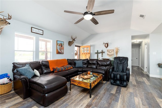 living area with baseboards, visible vents, a ceiling fan, dark wood-style floors, and vaulted ceiling