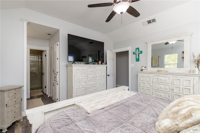 bedroom featuring visible vents, lofted ceiling, ceiling fan, wood finished floors, and ensuite bathroom