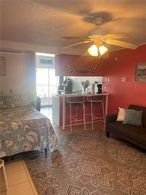 14300 S Padre Island Dr Unit 25, Corpus Christi, TX 78418 - bedroom with tile patterned flooring, a textured ceiling, and ceiling fan