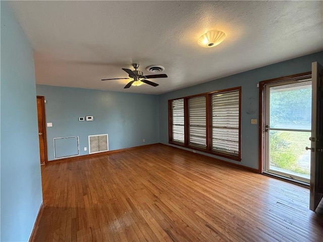 unfurnished living room featuring ceiling fan, a textured ceiling, and light hardwood / wood-style flooring