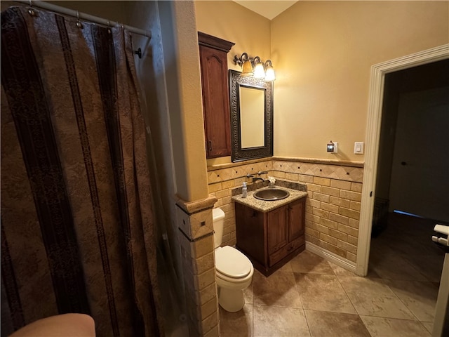 bathroom featuring tile walls, vanity, a shower with shower curtain, tile patterned flooring, and toilet