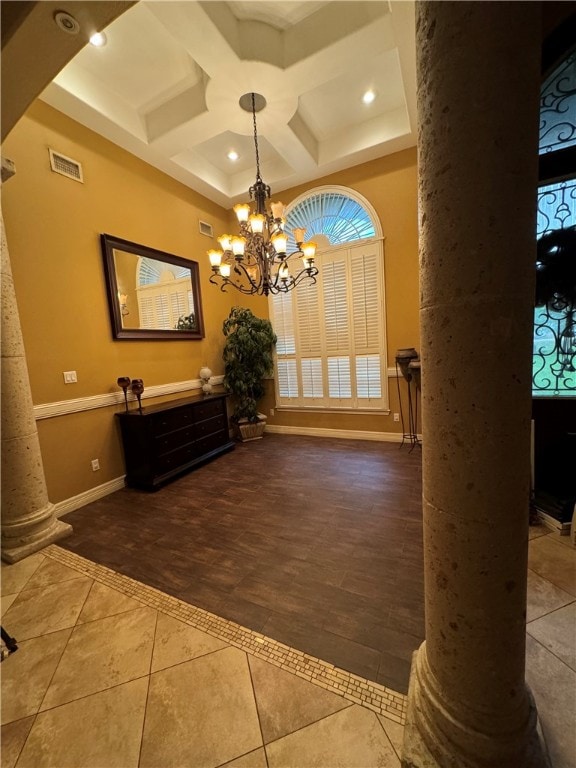 foyer featuring beamed ceiling, coffered ceiling, an inviting chandelier, and decorative columns