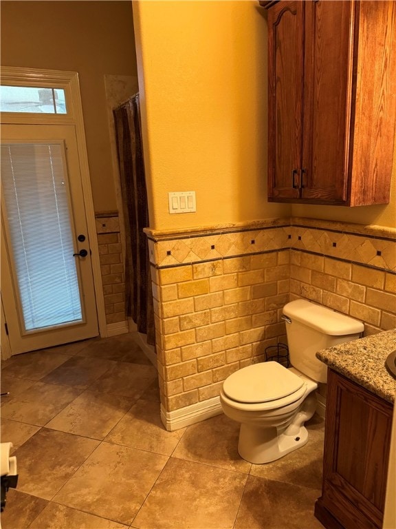 bathroom with walk in shower, vanity, and toilet