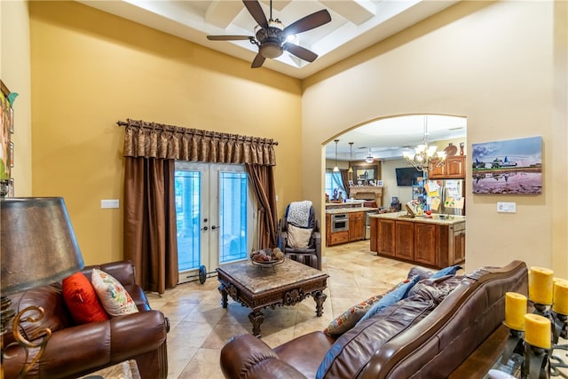 living room with french doors and ceiling fan with notable chandelier