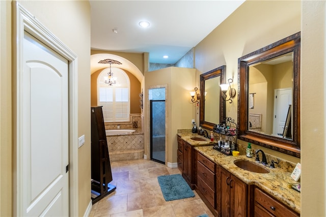 bathroom with a chandelier, vanity, shower with separate bathtub, and tile patterned floors