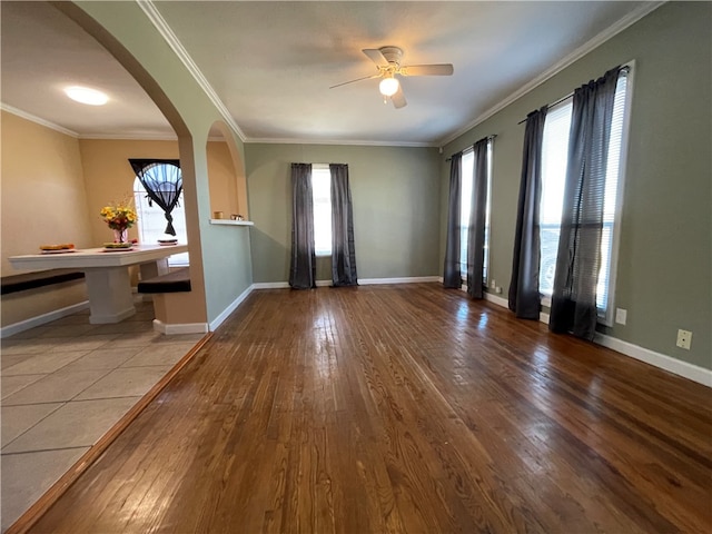 entrance foyer with hardwood / wood-style floors, a healthy amount of sunlight, and ornamental molding