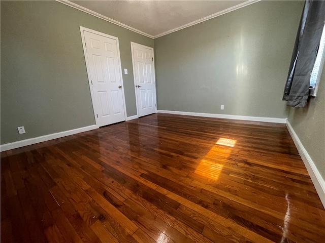 unfurnished bedroom featuring dark hardwood / wood-style floors and ornamental molding