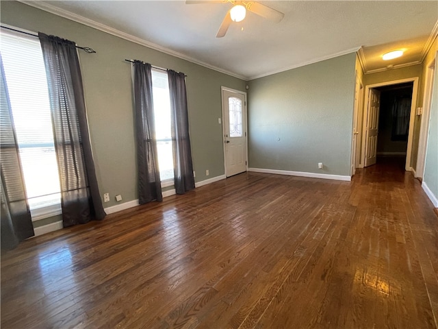 spare room featuring ornamental molding, ceiling fan, and dark wood-type flooring