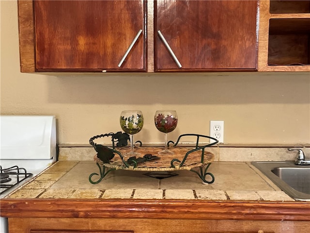 kitchen featuring tile counters and sink