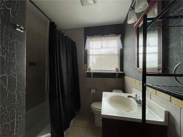 bathroom featuring tile patterned flooring, vanity, tile walls, and toilet