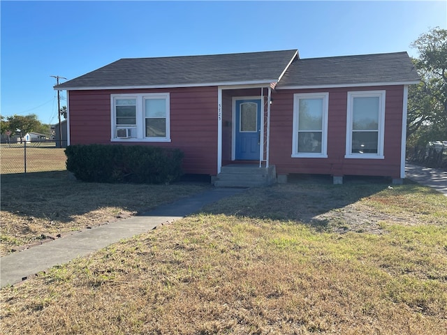 view of front of house with cooling unit and a front lawn