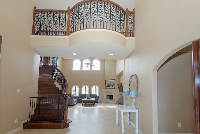 tiled entryway with a towering ceiling