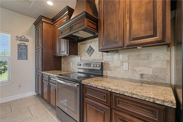 3941 Cobb Ln, Robstown, TX 78380 - kitchen with stainless steel electric range oven, custom exhaust hood, baseboards, decorative backsplash, and recessed lighting